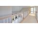 Hallway with white railing overlooking a room with large windows and a vaulted ceiling, enhancing its appeal at 1140 Matheson Way, Alpharetta, GA 30022
