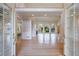 Spacious living room with hardwood floors, large windows, fireplace, and an open entryway to another room at 1140 Matheson Way, Alpharetta, GA 30022