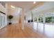 Bright, open-concept living room with large windows, hardwood floors, fireplace, and a high ceiling at 1140 Matheson Way, Alpharetta, GA 30022