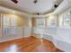 Sitting room with hardwood floors, built-in bench, and natural light from many windows at 1140 Matheson Way, Alpharetta, GA 30022
