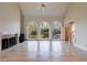 Bright and airy living room with fireplace, hardwood floors, tall windows, and a ceiling fan at 1140 Matheson Way, Alpharetta, GA 30022