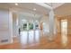 Bright living room featuring a fireplace, hardwood floors, large windows, and architectural columns at 1140 Matheson Way, Alpharetta, GA 30022