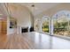Open living room with hardwood floors, large windows, fireplace, and a vaulted ceiling at 1140 Matheson Way, Alpharetta, GA 30022