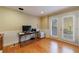 Home office with hardwood floors, wainscotting, and french doors that fill the space with natural light at 1140 Matheson Way, Alpharetta, GA 30022