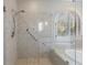 Tiled shower with glass enclosure and arched window at 1140 Matheson Way, Alpharetta, GA 30022
