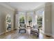 Charming sitting area with bay window, plantation shutters, hardwood floors, and stylish armchairs at 1140 Matheson Way, Alpharetta, GA 30022