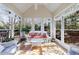 Bright sunroom with large windows overlooking natural scenery at 1140 Matheson Way, Alpharetta, GA 30022