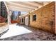 A patio area is situated on the back of this brick home, with a wooden beam pergola at 3065 Kings Nw Dr, Kennesaw, GA 30144