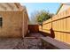 Fully fenced backyard, with a brick wall, small bench and a stone patio at 3065 Kings Nw Dr, Kennesaw, GA 30144