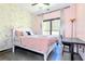 Comfortable bedroom with a large window, decorative wallpaper, and stylish curtains at 3065 Kings Nw Dr, Kennesaw, GA 30144