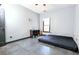 Minimalist bedroom with tile floors and a large window providing plenty of natural light at 3065 Kings Nw Dr, Kennesaw, GA 30144