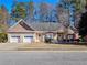Charming single-story brick home featuring a two-car garage and well-manicured front yard at 3065 Kings Nw Dr, Kennesaw, GA 30144