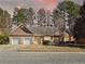 Charming single-story brick home featuring a two-car garage and well-manicured front yard at 3065 Kings Nw Dr, Kennesaw, GA 30144