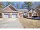 Charming single-story brick home featuring a two-car garage and well-manicured front yard at 3065 Kings Nw Dr, Kennesaw, GA 30144