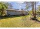 The back of the gray brick home is visible in a shady, landscaped backyard location at 1526 Colony East Cir, Stone Mountain, GA 30083