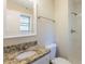 Bathroom featuring a shower, granite countertop, new toilet and modern finishes at 1526 Colony East Cir, Stone Mountain, GA 30083
