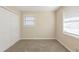 This bedroom features neutral walls, a window, carpet flooring and a double door closet at 1526 Colony East Cir, Stone Mountain, GA 30083