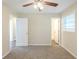 This bedroom has a ceiling fan, neutral walls, and views to two other rooms at 1526 Colony East Cir, Stone Mountain, GA 30083