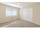 This bedroom features neutral walls, carpet flooring, natural light and a closet at 1526 Colony East Cir, Stone Mountain, GA 30083