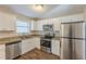 Modern kitchen featuring stainless steel appliances, granite countertops, and white cabinets at 1526 Colony East Cir, Stone Mountain, GA 30083