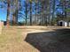 Expansive backyard featuring mature trees, a wooden fence, and a storage shed for all your outdoor needs at 1840 Sw King Alfred Sw Dr, Atlanta, GA 30331