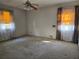 Bedroom featuring a ceiling fan and bright windows with patterned curtains, offering natural light at 1840 Sw King Alfred Sw Dr, Atlanta, GA 30331
