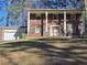 Traditional two-story brick home with a welcoming front entrance, green shutters, and attached garage at 1840 Sw King Alfred Sw Dr, Atlanta, GA 30331
