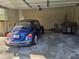 Attached garage featuring ample space for parking, additional storage, and a blue vehicle at 1840 Sw King Alfred Sw Dr, Atlanta, GA 30331