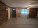 Spacious living room with brick and wooden walls, and carpet flooring at 1840 Sw King Alfred Sw Dr, Atlanta, GA 30331