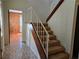 View of carpeted stairs with white railing leading to the upper level of the home at 1840 Sw King Alfred Sw Dr, Atlanta, GA 30331