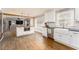 Modern kitchen with white cabinets, stainless appliances, butcher block island, and hardwood floors at 2597 Churchwell Ln, Tucker, GA 30084