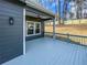 Inviting back deck features gray wood, a fenced yard, and exterior lighting for outdoor relaxation at 113 Miller Rd, Stockbridge, GA 30281