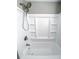 Clean white bathtub and shower combination with built-in shelving and modern fixtures at 113 Miller Rd, Stockbridge, GA 30281