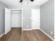 Bedroom features neutral walls, wood flooring, and a walk-in closet at 113 Miller Rd, Stockbridge, GA 30281