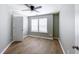 This bedroom features neutral walls, wood flooring, and a ceiling fan at 113 Miller Rd, Stockbridge, GA 30281
