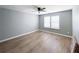 Bedroom with neutral walls, wood flooring, ceiling fan and mini-blinds at 113 Miller Rd, Stockbridge, GA 30281