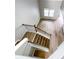 View of staircase with hardwood treads and dark railings, with natural light and new paint at 113 Miller Rd, Stockbridge, GA 30281