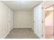 Spacious basement area with neutral carpet, white trim, and an open doorway leading to another level at 2167 Kilarney Rd, Decatur, GA 30032