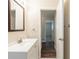 Well-lit bathroom featuring a modern vanity and wood-look flooring at 2167 Kilarney Rd, Decatur, GA 30032