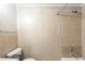 Tiled shower and tub in bathroom feature neutral tile and stylish mosaic accents at 2167 Kilarney Rd, Decatur, GA 30032
