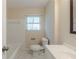 Clean bathroom featuring white tiles, a modern vanity, and a bathtub with shower at 2167 Kilarney Rd, Decatur, GA 30032