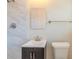 Bright bathroom featuring a marble tile wall and new fixtures at 2167 Kilarney Rd, Decatur, GA 30032