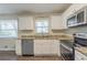 Beautifully updated kitchen with granite countertops, stainless steel appliances, and ample cabinet space at 2167 Kilarney Rd, Decatur, GA 30032