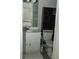 This bathroom features white vanity cabinets and a decorative, dark cabinet over the toilet at 2744 Snapfinger Mnr, Decatur, GA 30035