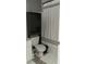 Bathroom features a black storage cabinet over the toilet, as well as a white and gray shower curtain at 2744 Snapfinger Mnr, Decatur, GA 30035