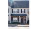 Charming townhome with brick accents, black shutters, and a welcoming front porch at 2744 Snapfinger Mnr, Decatur, GA 30035
