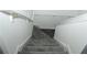 Carpeted staircase with white railing offers a safe descent to the lower level of the home at 2744 Snapfinger Mnr, Decatur, GA 30035
