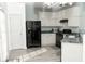 Modern kitchen with white cabinets, black appliances, and gray countertop at 2744 Snapfinger Mnr, Decatur, GA 30035