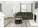 Cozy living room with a fireplace, a comfortable sofa, and a view of the front door at 2744 Snapfinger Mnr, Decatur, GA 30035