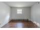 Basement featuring wood-look floors and white painted walls with one small window at 4342 Lincolndale Dr, Ellenwood, GA 30294